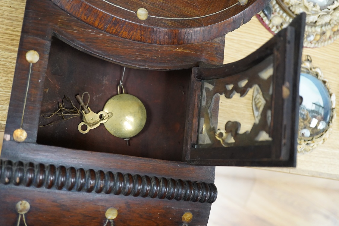 A late 19th century mahogany wall clock with mother of pearl inlaid discs, with pendulum and key, 67cm high